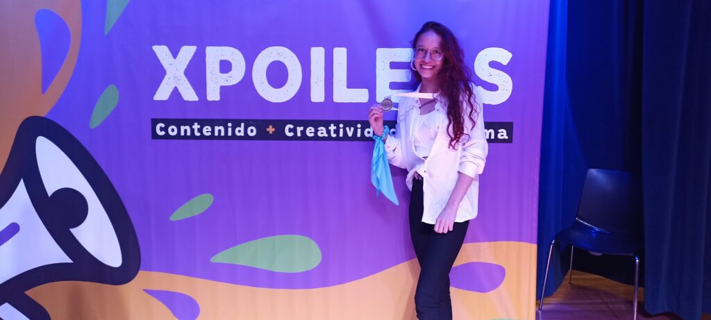 Imagen muestra a la estudiante ganadora en la categoría Artes y humanidades en el evento Xpoilers