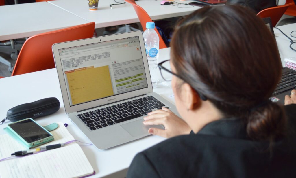 Person using a computer, viewing a document.