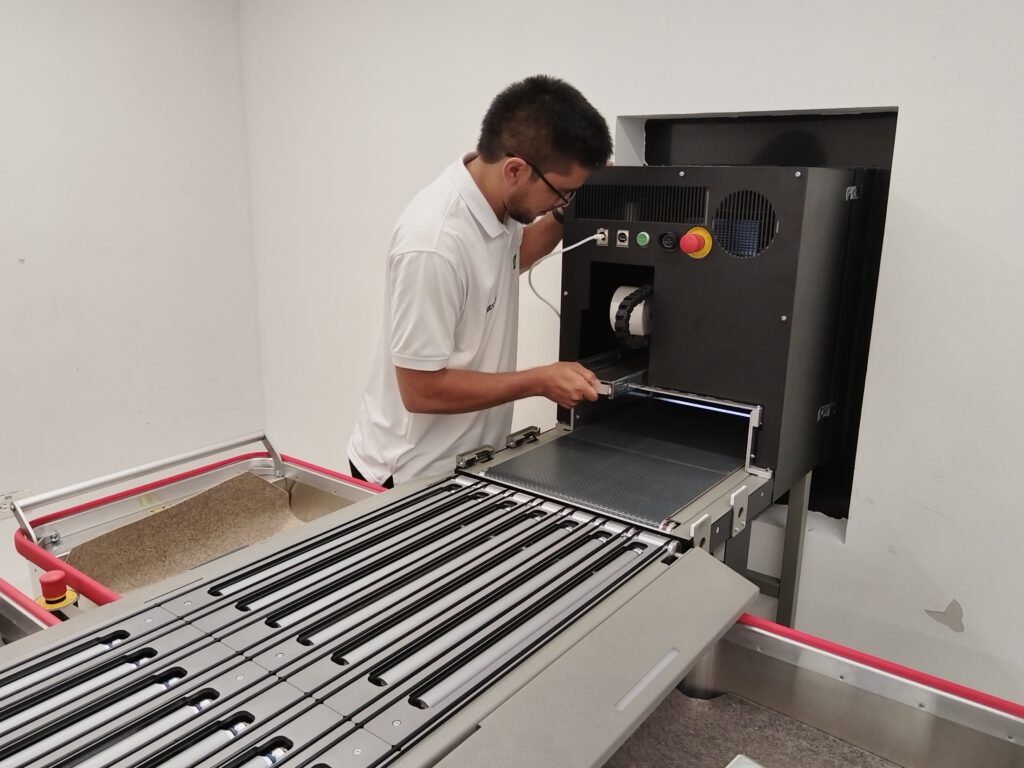 Central Library engineer next to the new auto-devolution equipment.
