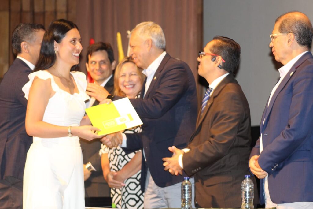 Imagen que muestra a Leidy Sierra recogiendo el diploma de ganadora del Premio Eloy Valenzuela.