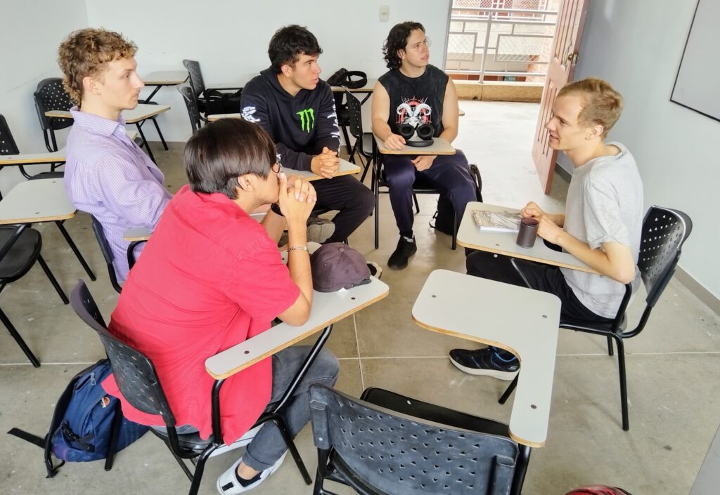 German student and volunteer, Levin Seidinger, participating in a meeting with a conversation club.