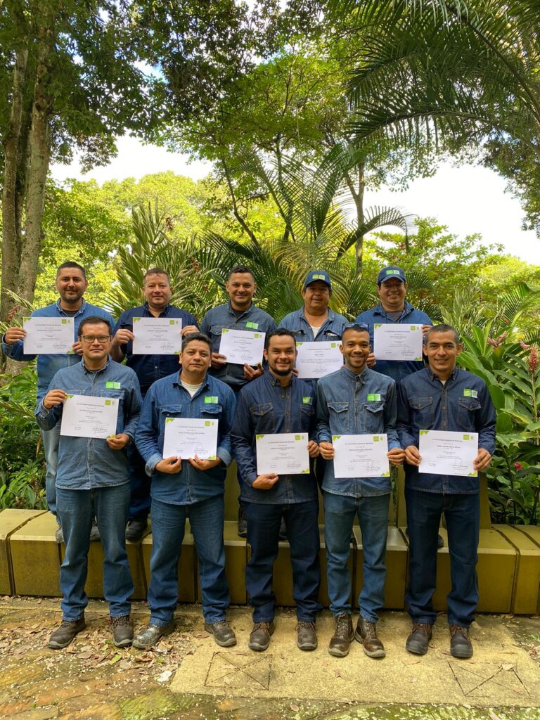 Physical plant employees posing with course approval certificate.